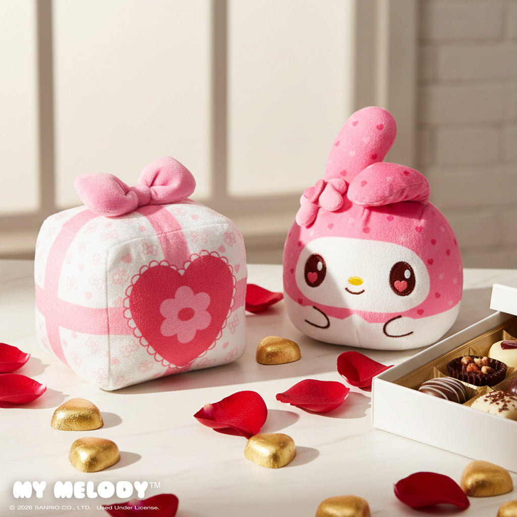 Valentine Present My Melody 4" Reversible Plushie on a table surrounded by red petals, chocolates, and a chocolate box