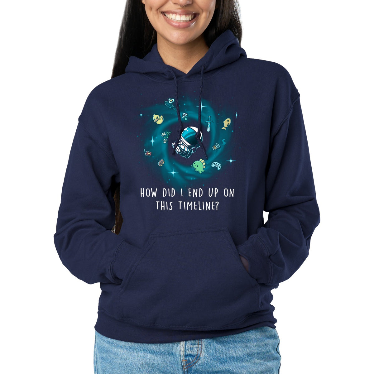 Pullover Hoodie_TeeTurtle navy How Did I End Up On This Timeline Pullover Hoodie featuring an astronaut floating in the middle of a black hole surrounded by random objects like a sword, frying pan, rubber duck, and game controller. Below the illustration the text rreads "How Did I End Up On This Timeline?"