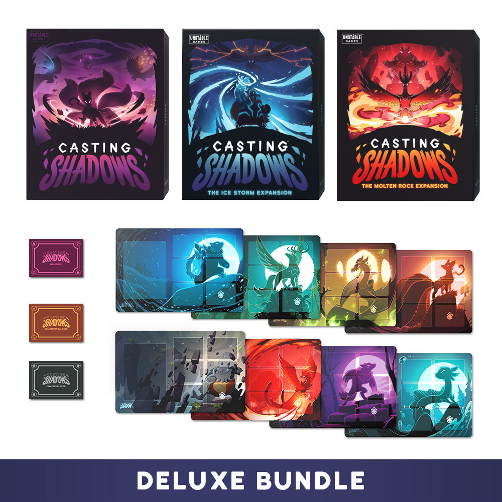 Showcase of the Unstable Games' "Casting Shadows: Deluxe Bundle," featuring the base game, two expansions ("The Ice Storm" and "The Molten Rock"), along with additional cards and components meticulously arranged in rows.