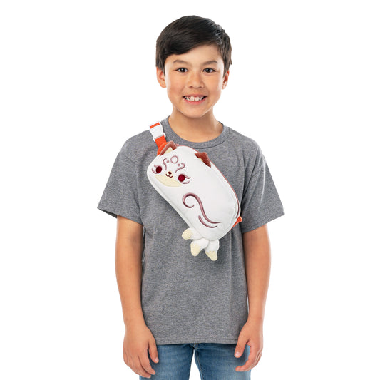 Young boy smiling, wearing a grey t-shirt and holding a TeeTurtle Plushiverse Magical Kitsune Fanny Pack shaped like a white and red chicken.