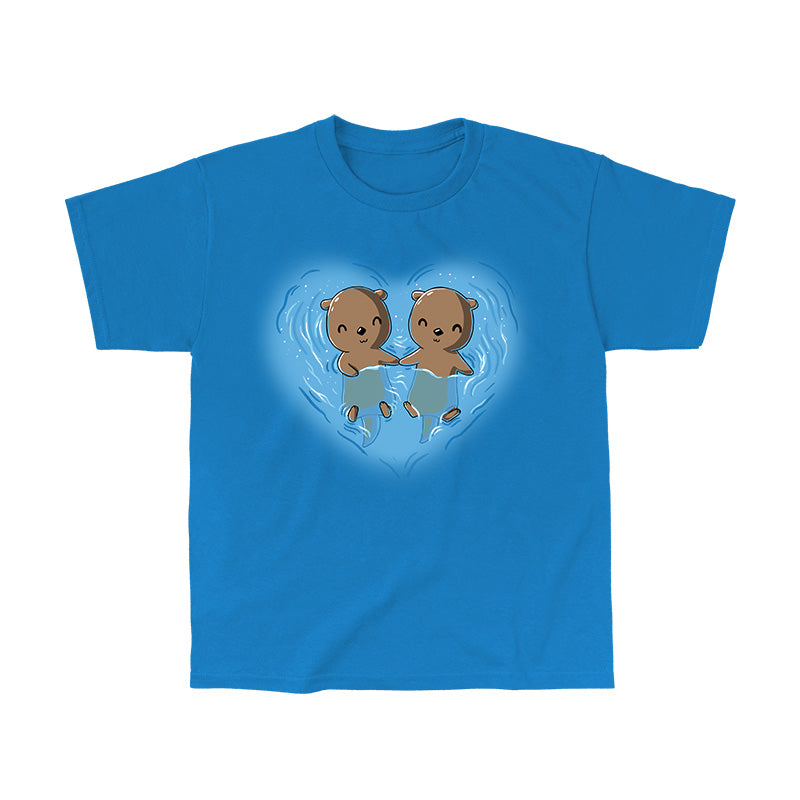 Classic Cotton T-shirt_TeeTurtle My Otter Half sapphire blue t-shirt featuring two otters holding hands while floating on their backs in water, surrounded by ripples in a heart shape.