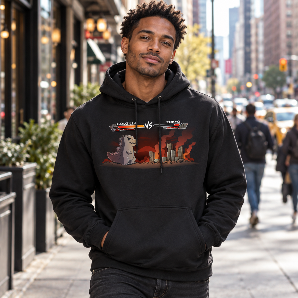 Pullover Hoodie_TeeTurtle black Godzilla Fight Screen Pullover Hoodie featuring Godzilla facing a burning Tokyo skyline in a retro fighting game scene with health bars labeled "Godzilla" and "Tokyo."