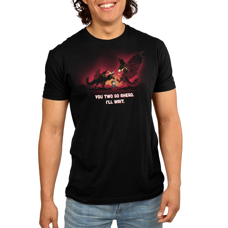 Premium Cotton T-shirt_TeeTurtle black You Two Go Ahead. I'll Wait apparel featuring two boss monsters from Monster Hunter having an intense fight, with a hunter sitting in the middle of their battlefield, and the caption, "You Two Go Ahead. I'll Wait".