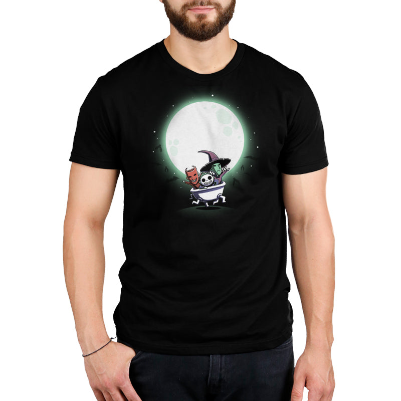 A man wearing The Nightmare Before Christmas Lock, Shock, and Barrel (Glow) t-shirt featuring an image of a witch on the moon.