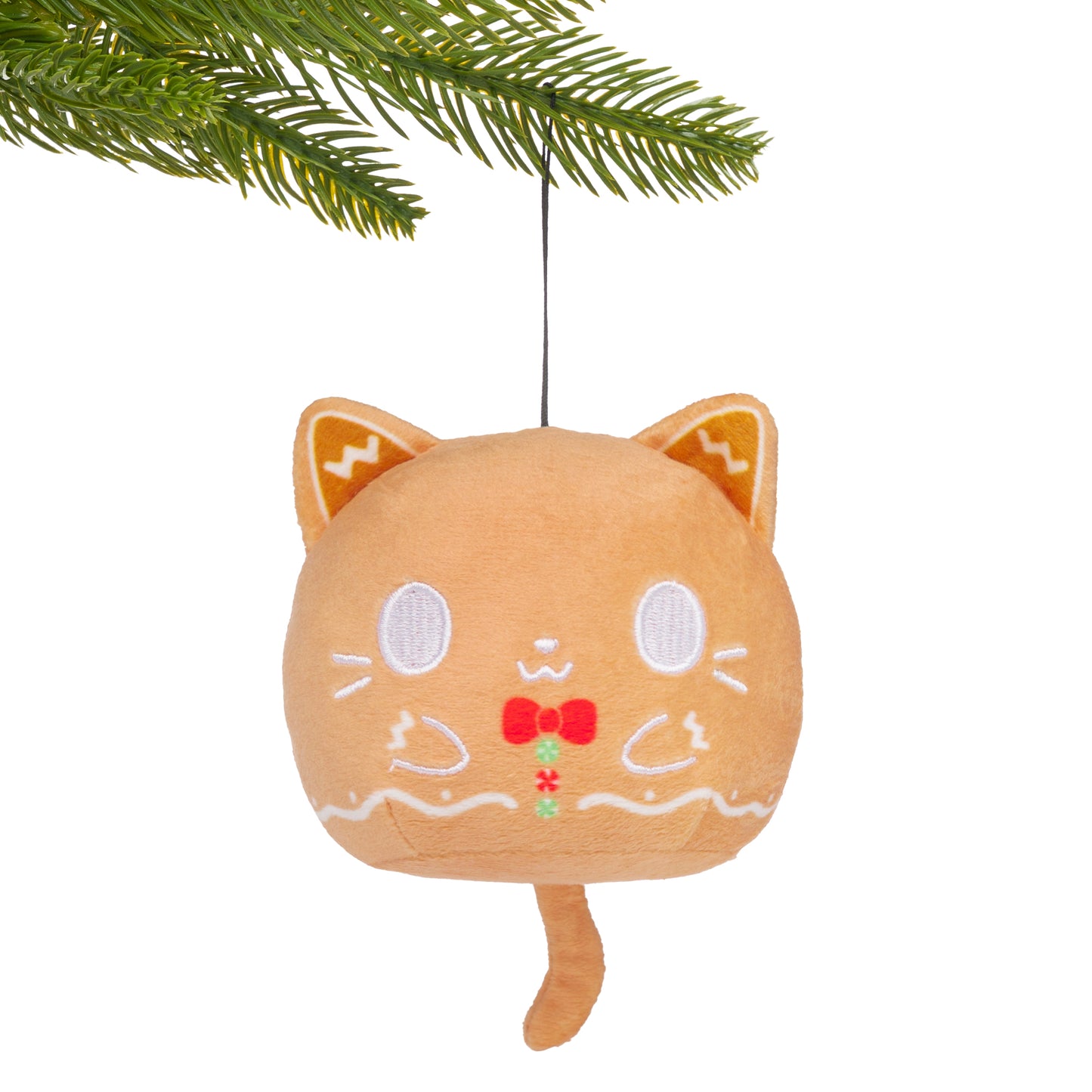Gingerbread Cat Plushie Ornament hanging from a branch