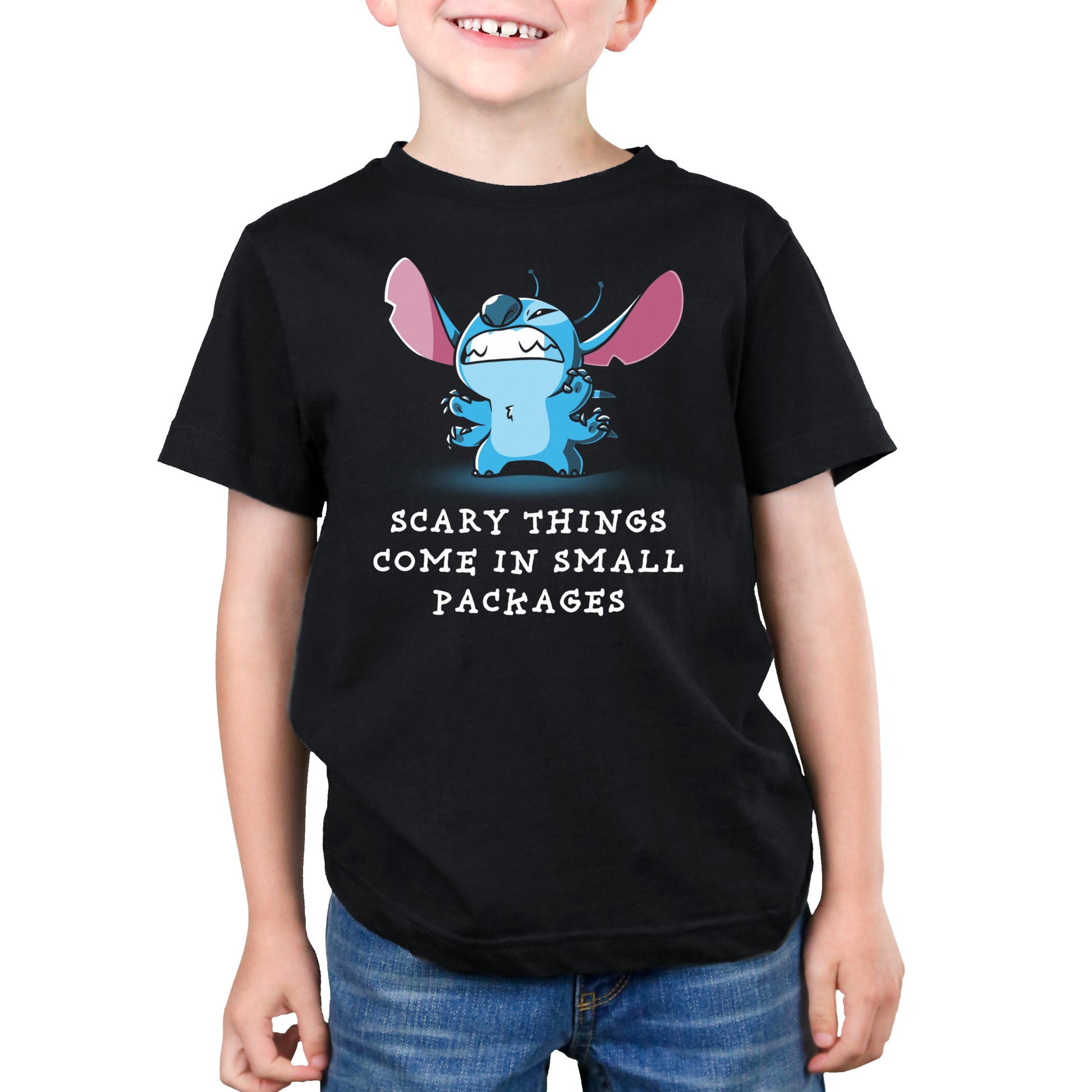 A young boy wearing a Disney t-shirt with the slogan "Scary Things Come in Small Packages.