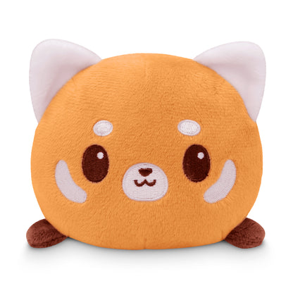 Round TeeTurtle plush toy with a cat-like design featuring orange and white colors and an embroidered face.