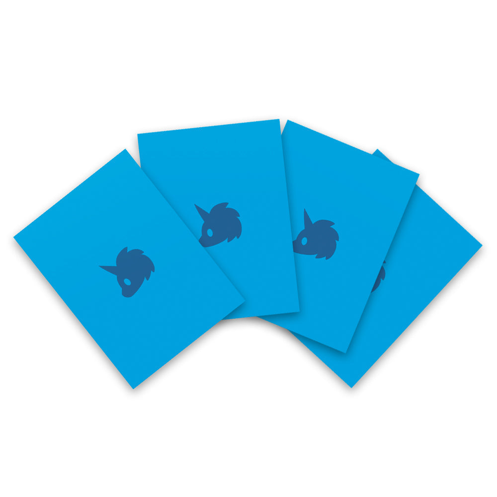 Five blue Tic Tac K.O. Dragons vs. Unicorns: Team Unicorn card sleeves with a dark blue dragon-like creature silhouette printed on them, arranged overlapping on a white background by Unstable Games.