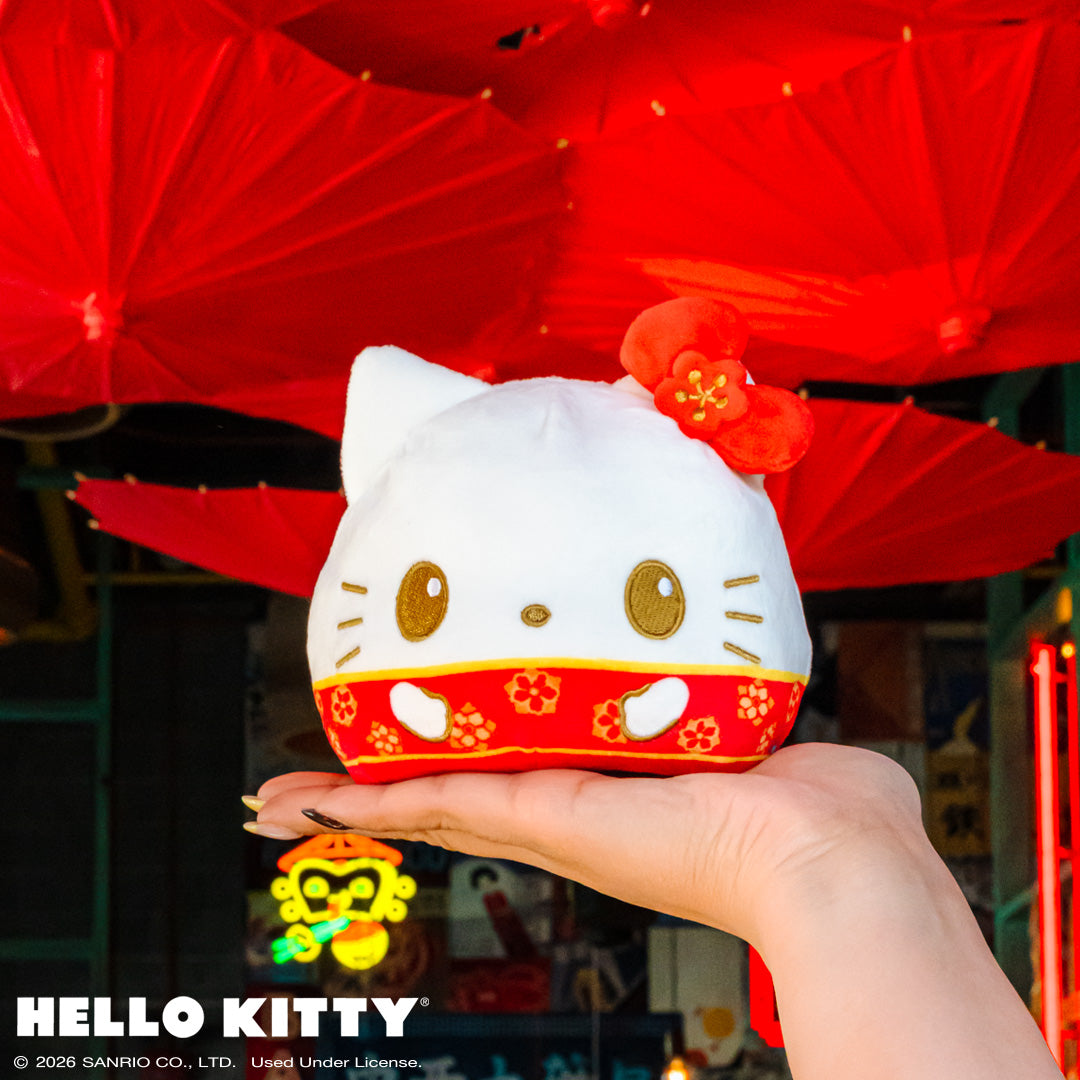 Lunar New Year Horse Hello Kitty 4" Reversible held up in the air with red paper umbrellas and an Eastern storefront in the background