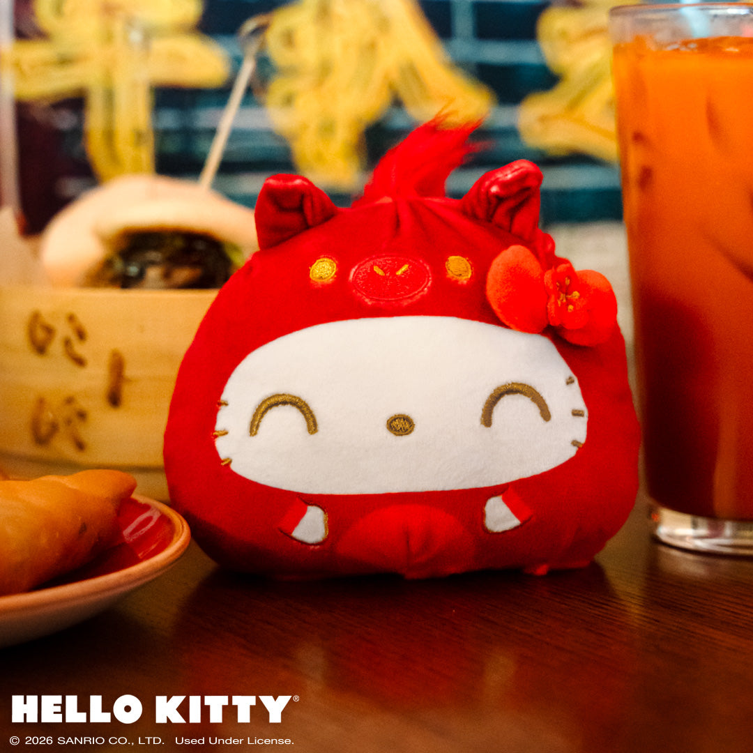 Lunar New Year Horse Hello Kitty 4" Reversible sitting on a table with Lunar New Year food and drinks