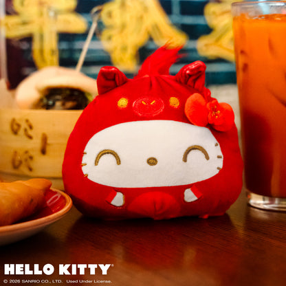 Lunar New Year Horse Hello Kitty 4" Reversible sitting on a table with Lunar New Year food and drinks