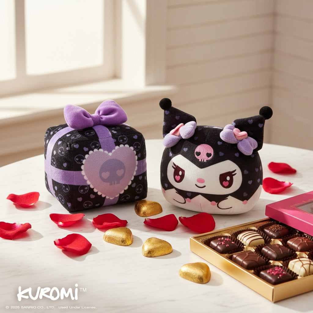Valentine Present Kuromi 4" Reversible Plushie on a table surrounded by red petals, chocolates, and a chocolate box