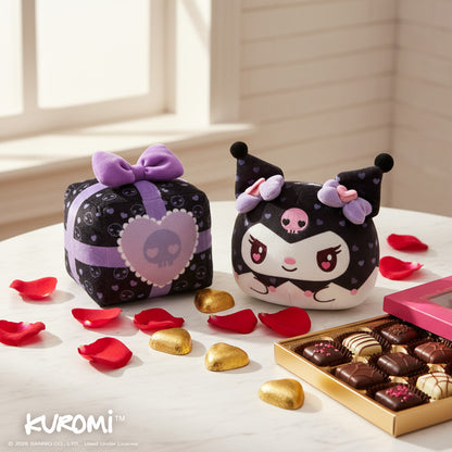 Valentine Present Kuromi 4" Reversible Plushie on a table surrounded by red petals, chocolates, and a chocolate box