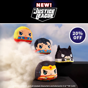 Four small plush Justice League character toys floating in a stylized cloud scene, with a black banner at the top reading NEW! Justice League and a purple circle that says 20% OFF.