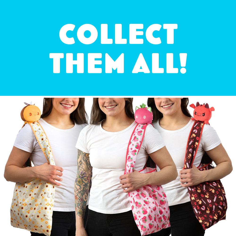Three women holding TeeTurtle bags with the text collect them all. The bags include a secret Plushiverse Quill of the Raven Plushie Tote Bag and velcro storage pouch.