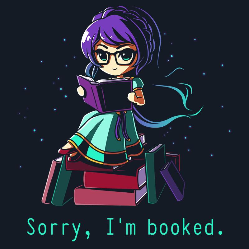 Illustration of a girl with glasses and purple hair, reading a book while sitting on a stack of books. The text "Sorry, I'm booked." is featured on a super soft ringspun cotton, unisex tee in navy blue. Product Name: Sorry I'm Booked. Brand Name: monsterdigital