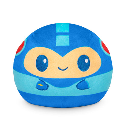 A soft and cuddly Plushiverse Mega Man and Rush 4" Reversible Plushie from TeeTurtle in the shape of a cute, smiling character wearing a blue helmet and suit with large eyes and small arms. This stuffed toy is perfect for snuggling.