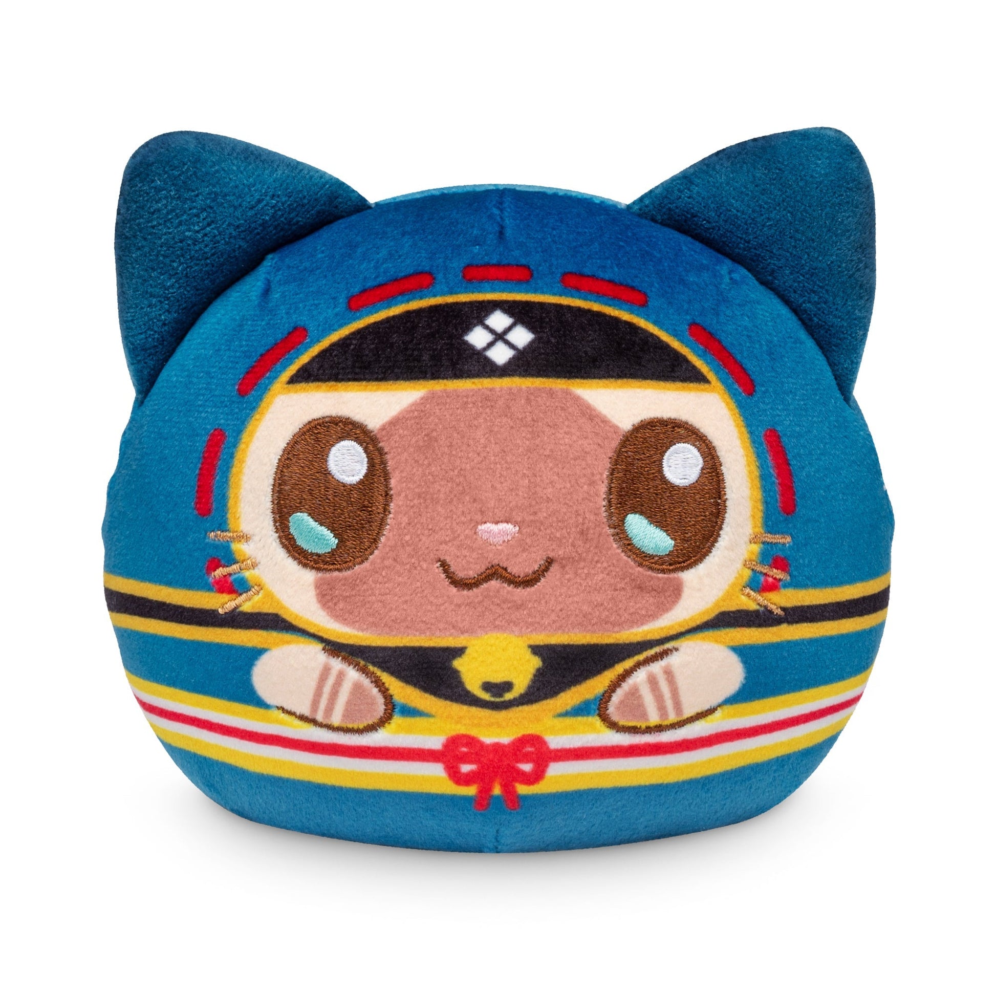 A Plushiverse Palico 4" Reversible Plushie in the shape of a cat with large eyes, blue ears, and a colorful, detailed design, including red, yellow, and black patterns on its body. This adorable stuffed toy comes from the Monster Hunter collection.