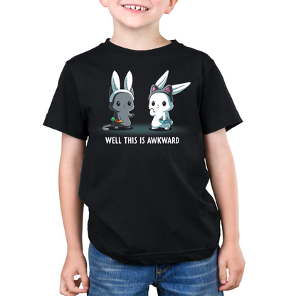 Premium Cotton T-shirt_TeeTurtle black Well This Is Awkward Premium Cotton T-shirt featuring a a cat in bunny ears holding a carrot and a bunny in cat ears holding a piece of fish. Both look unsettled. Text at the bottom reads "Well This Is Awkward"