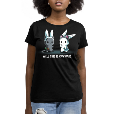 Premium Cotton T-shirt_TeeTurtle black Well This Is Awkward Premium Cotton T-shirt featuring a a cat in bunny ears holding a carrot and a bunny in cat ears holding a piece of fish. Both look unsettled. Text at the bottom reads "Well This Is Awkward"