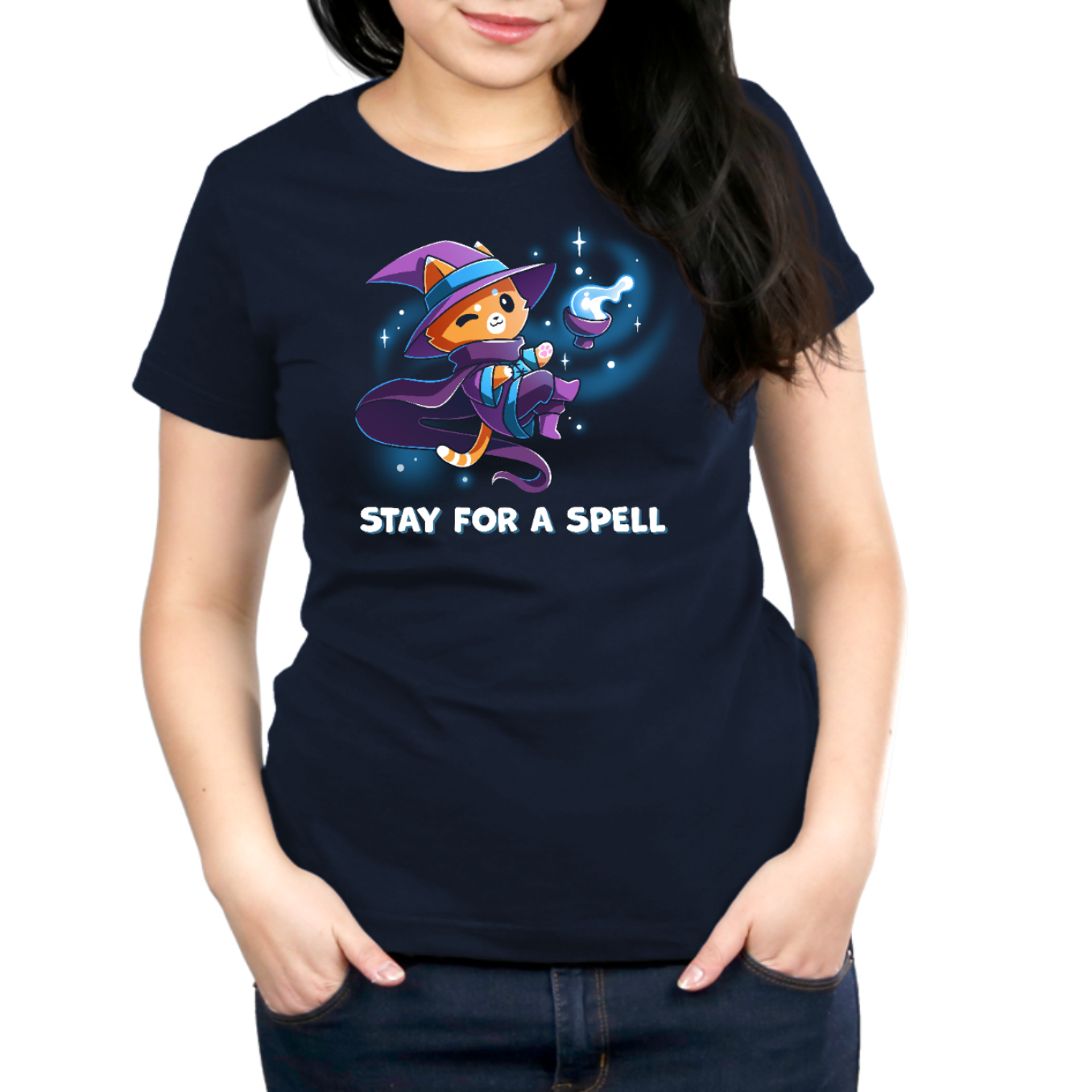 Premium Cotton T-shirt_TeeTurtle navy Stay For A Spell Premium Cotton T-shirt featuring an orange cat dressed as a witch, floating in space with a cauldron floating nearby. The cat is winking and the text at the bottom reads "Stay For A Spell" 