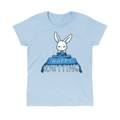 Classic Cotton T-shirt_TeeTurtle light blue Happy Knitting apparel featuring a bunny knitting a large blue blanket whose tassels end in the knitted words, “Happy Knitting“.