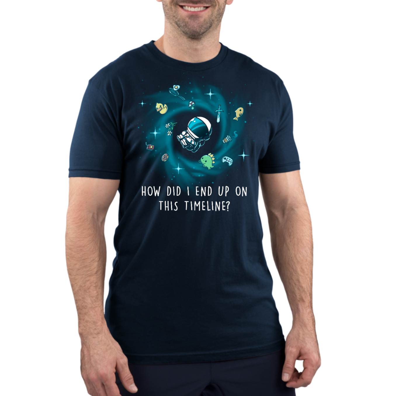 Premium Cotton T-shirt_TeeTurtle navy How Did I End Up On This Timeline Premium Cotton T-shirt featuring an astronaut floating in the middle of a black hole surrounded by random objects like a sword, frying pan, rubber duck, and game controller. Below the illustration the text rreads "How Did I End Up On This Timeline?"