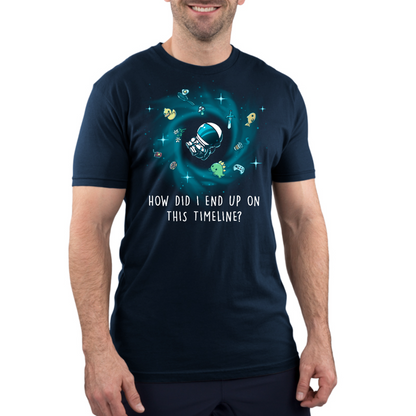 Premium Cotton T-shirt_TeeTurtle navy How Did I End Up On This Timeline Premium Cotton T-shirt featuring an astronaut floating in the middle of a black hole surrounded by random objects like a sword, frying pan, rubber duck, and game controller. Below the illustration the text rreads "How Did I End Up On This Timeline?"