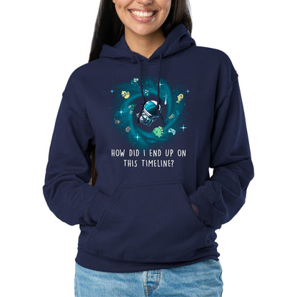 Pullover Hoodie_TeeTurtle navy How Did I End Up On This Timeline Pullover Hoodie featuring an astronaut floating in the middle of a black hole surrounded by random objects like a sword, frying pan, rubber duck, and game controller. Below the illustration the text rreads "How Did I End Up On This Timeline?"