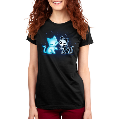 Women's Premium T-shirt_TeeTurtle black Purranormal Pals Women's Premium T-Shirt featuring a glowing blue ghost cat sitting beside a smiling skeleton cat, surrounded by small blue stars.
