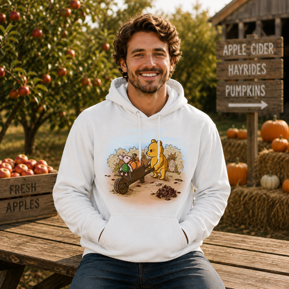 Pullover Hoodie_TeeTurtle white A Perfect Autumn Day Pullover Hoodie featuring a bear pulling a wagon filled with pumpkins while a little mouse rides along, surrounded by autumn bushes, fallen leaves, and tree stumps on a crisp fall day.