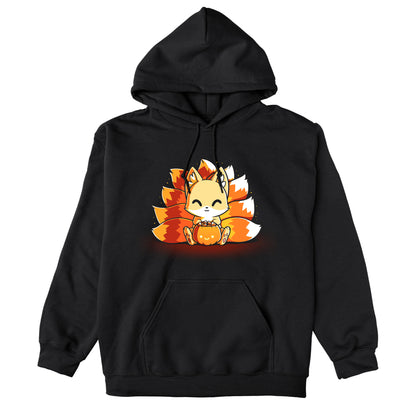 Pullover Hoodie_TeeTurtle Candy Corn Kitsune black t-shirt featuring a happy kitsune holding a Halloween jack-o-lantern full of candy corn.