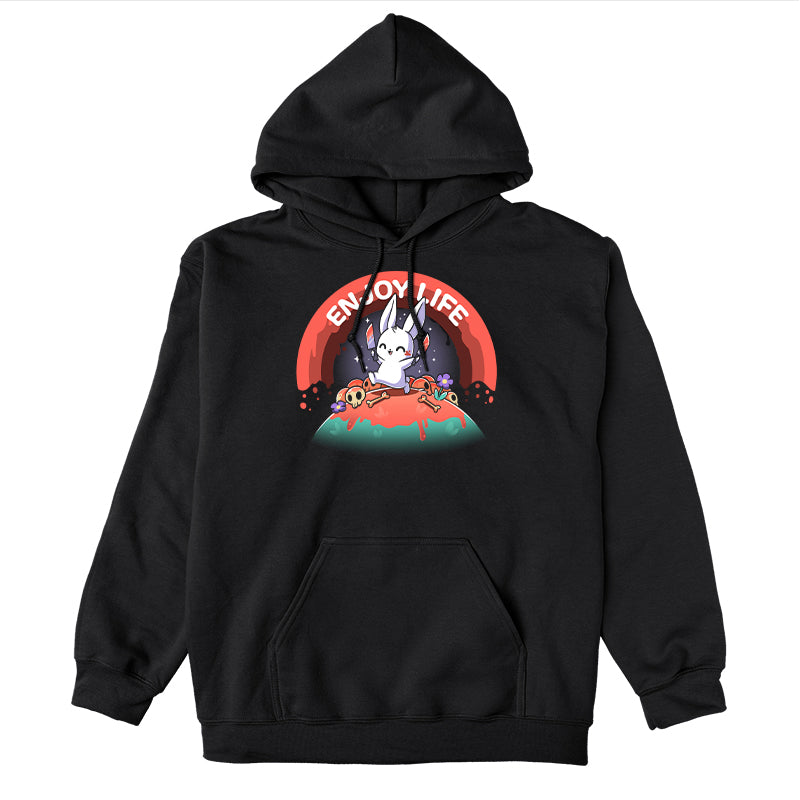 Pullover Hoodie_TeeTurtle black Enjoy Life apparel featuring a bunny holding bloody knives in both paws, and skipping on a grassy hill littered with blood, bones, and purple flowers with a bloody rainbow in the background, and the caption, “Enjoy Life“.