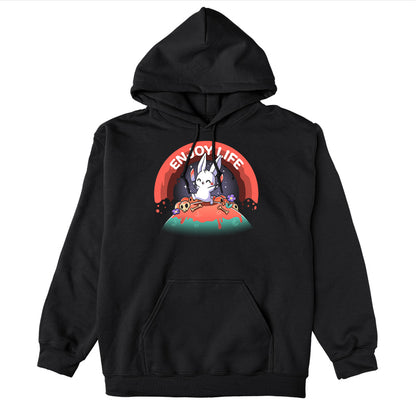 Pullover Hoodie_TeeTurtle black Enjoy Life apparel featuring a bunny holding bloody knives in both paws, and skipping on a grassy hill littered with blood, bones, and purple flowers with a bloody rainbow in the background, and the caption, “Enjoy Life“.