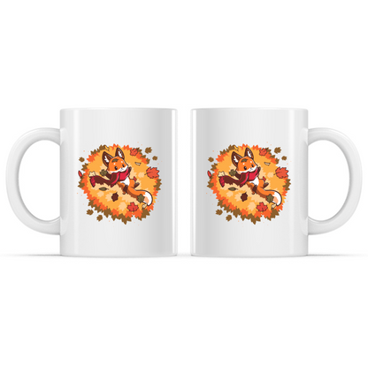 Ceramic Mug_TeeTurtle Autumn Fox white mug featuring a smiling fox wearing a cozy scarf while relaxing in a pile of colorful autumn leaves with leaves gently falling all around.