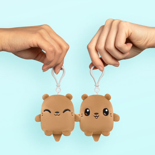 A pair of hands holding a pair of kawaii TeeTurtle Plushiverse My Otter Half Plushmates Besties teddy bears.