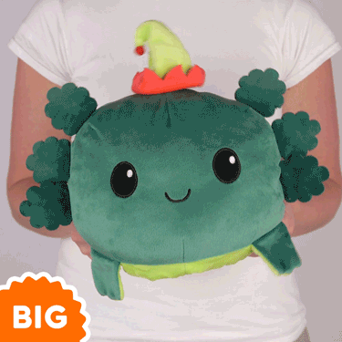 A woman is holding a TeeTurtle Big Reversible Axolotl Plushie (Elf Hat).