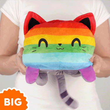 A woman is holding a TeeTurtle Big Reversible Cat Plushie.