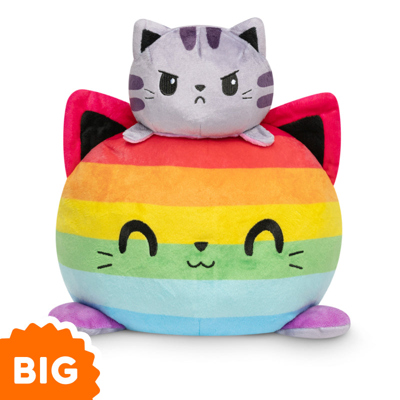 A TeeTurtle Big Reversible Cat Plushie is sitting on top of a rainbow ball.