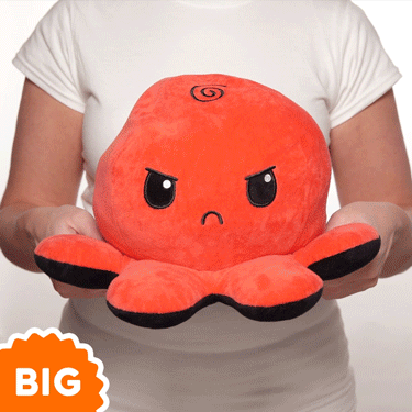 A woman holding a TeeTurtle Big Reversible Octopus Plushie (Red + Black) from the brand TeeTurtle.