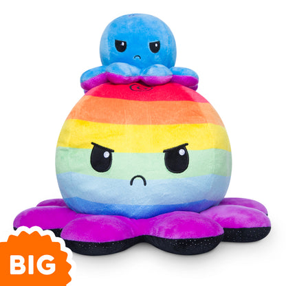 A TeeTurtle Big Reversible Octopus Plushie (Rainbow Stripes + Black Sparkle) is sitting on top of a rainbow octopus mood plushie.