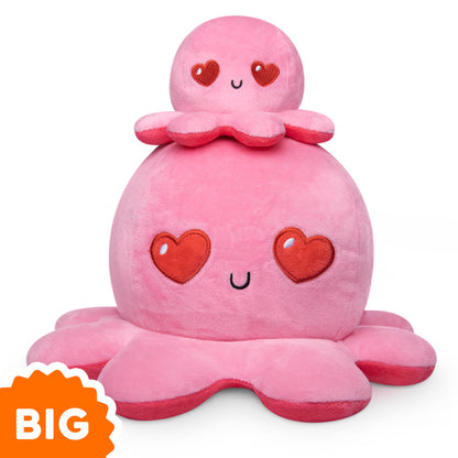 An original TeeTurtle Big Reversible Octopus Plushie (Red + Pink) with hearts on it.