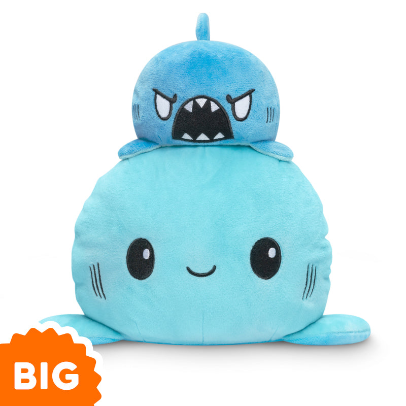 A TeeTurtle Big Reversible Shark Plushie (Blue + Light Blue), in the form of a blue plush shark, is stacked on top of another.