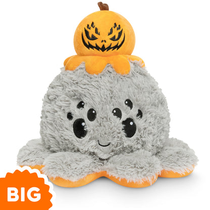 A TeeTurtle Big Reversible Spider Plushie with a pumpkin on top of it.