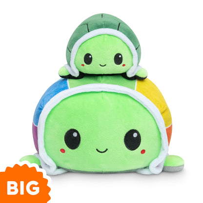 Two TeeTurtle Big Reversible Turtle Plushies (Rainbow Shell), sitting on top of each other in a mood.