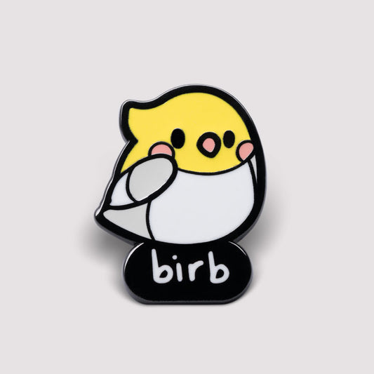 A yellow TeeTurtle Birb Pin with the word bird on it.
