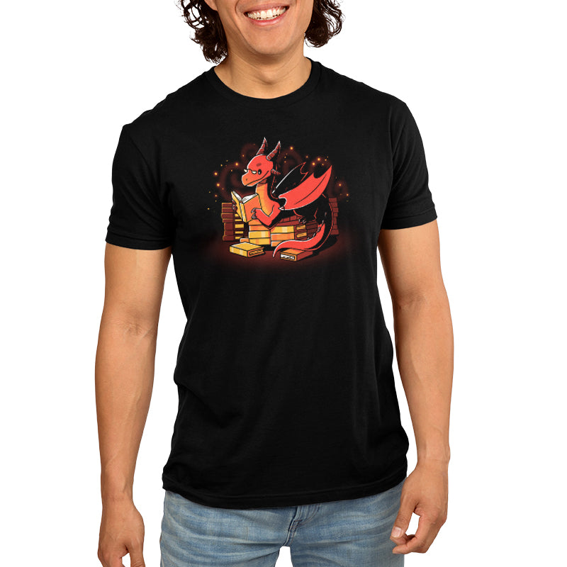 Premium Cotton T-shirt _TeeTurtle Book Hoarder black t-shirt featuring a red dragon with horns and wings, reading a book while sitting among piles of books against a dark background with glowing embers.