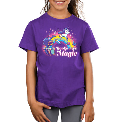 A girl wearing a purple T-shirt with the words "Books Are Magic (Unicorn)" and the TeeTurtle brand.