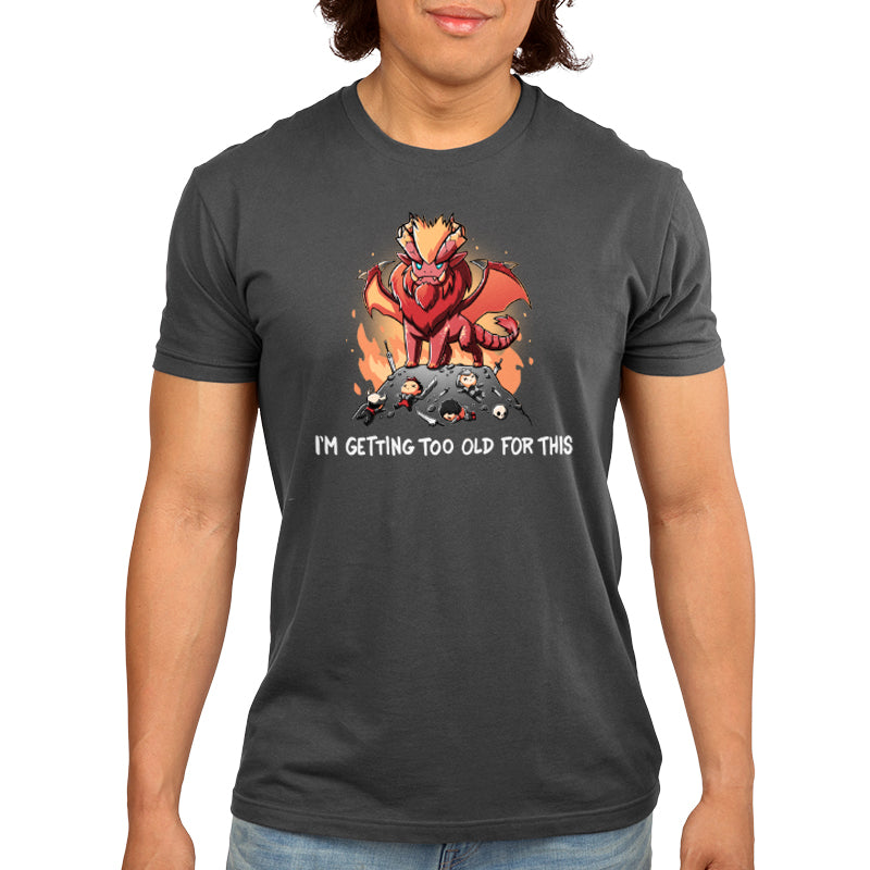 Premium Cotton T-shirt_TeeTurtle charcoal gray I'm Getting Too Old For This apparel featuring the elder dragon Teostra from Monster Hunter looming over fallen hunters and their equipment, with the caption, "I'm Getting Too Old For This".