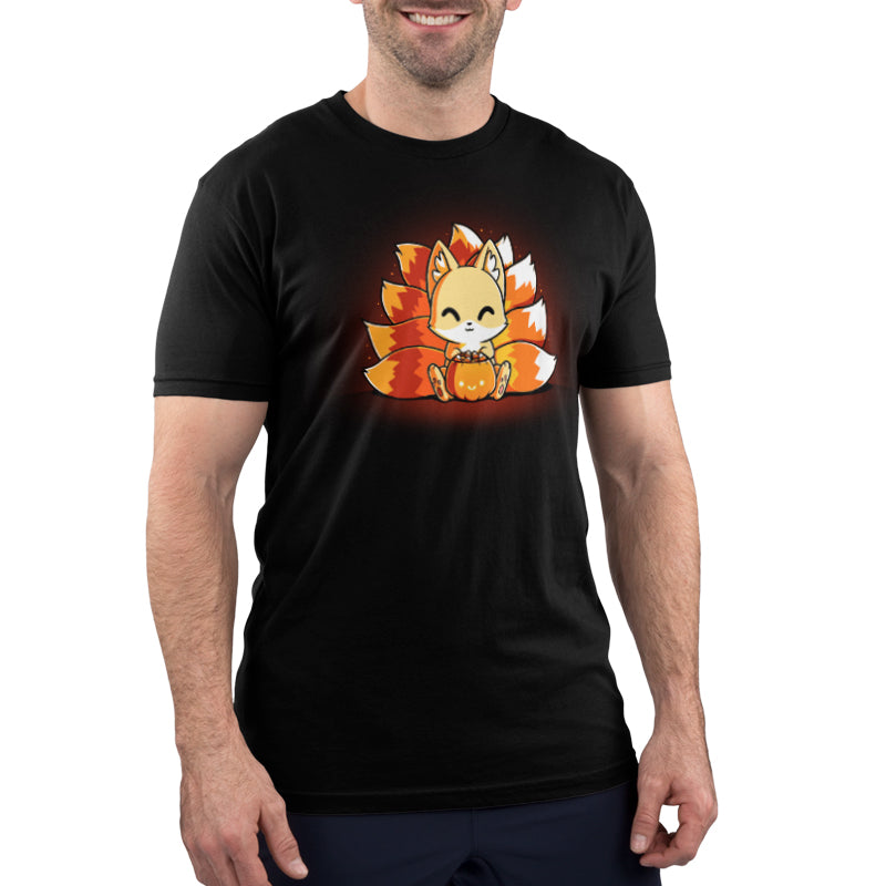 A man wearing a black t-shirt with an orange cat, the TeeTurtle Candy Corn Kitsune.